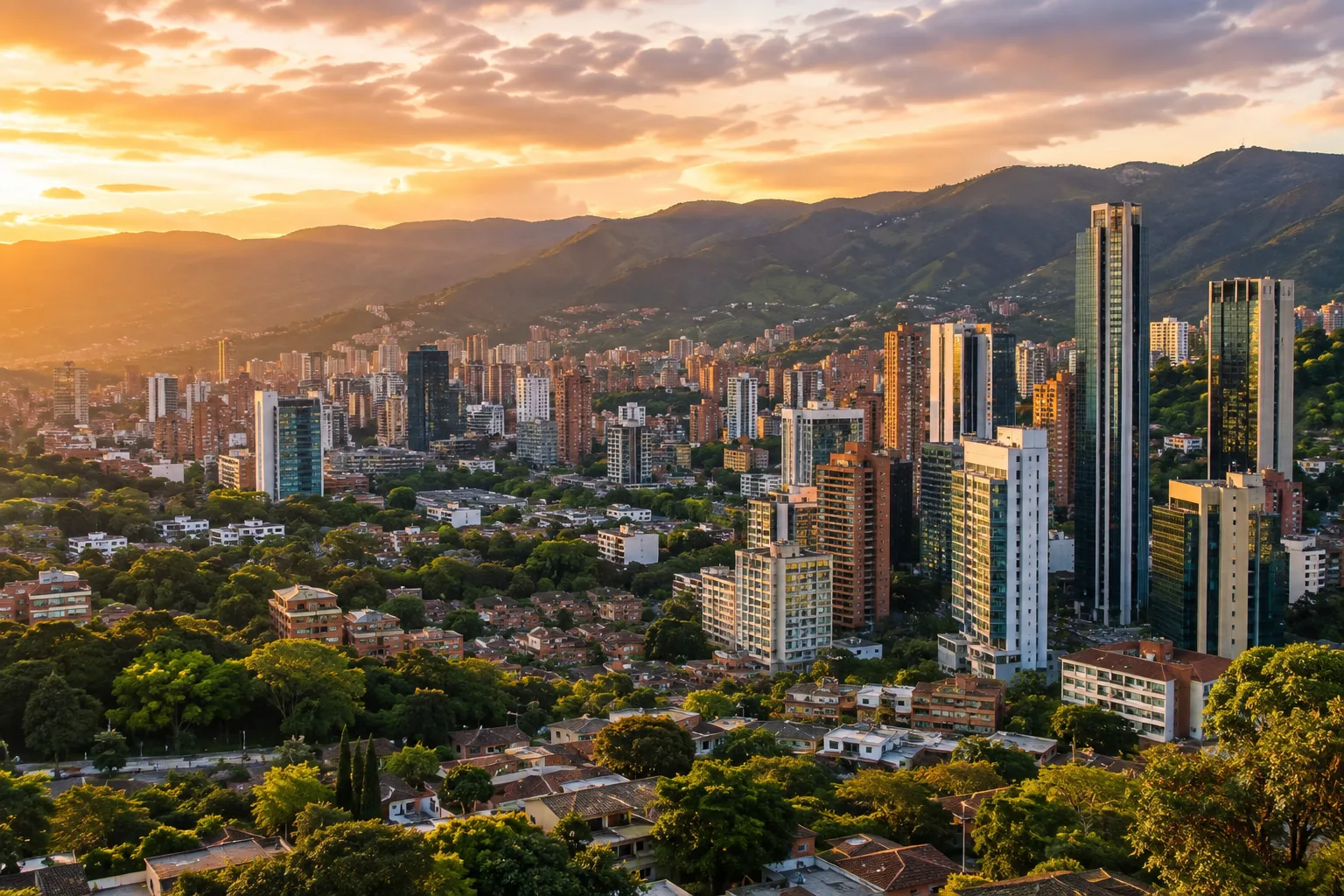 Medellín skyline at golden hour with green mountains behind El Poblado's towers
